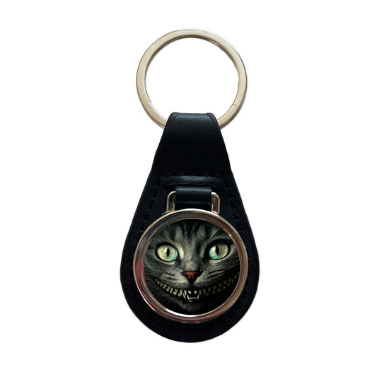 Mischievous Cheshire Cat Grin on Black Black Leather Metal Keychain